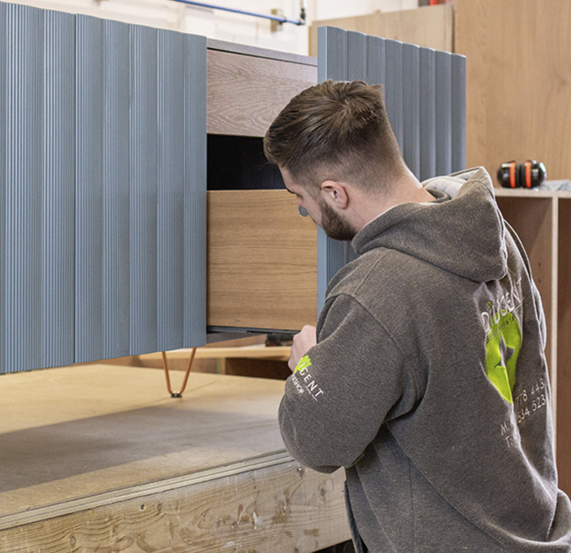 Craftsman in a workshop assembling a bespoke vanity unit